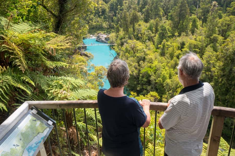 Greymouth: Hokitika Gorge and Tree Top Walkway Half-Day Tour - Walking across the swing bridge at Hokitika Gorge