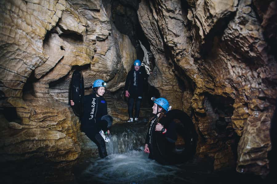 Waitomo Caves: Labyrinth Black Water Rafting Experience - Getting suited up for 10 to 14°C water